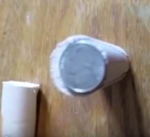 Place a nickel on top of dowel rod